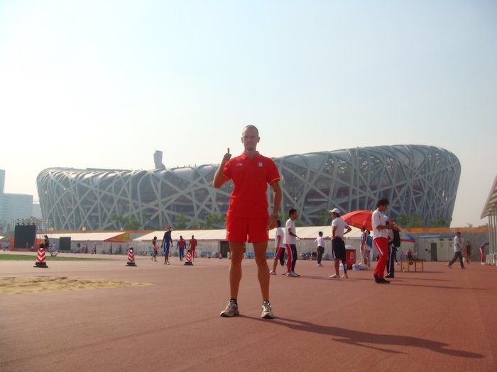 Foto en la pista de calentamiento con el majestuoso Estadio Olímpico del Nido detrás